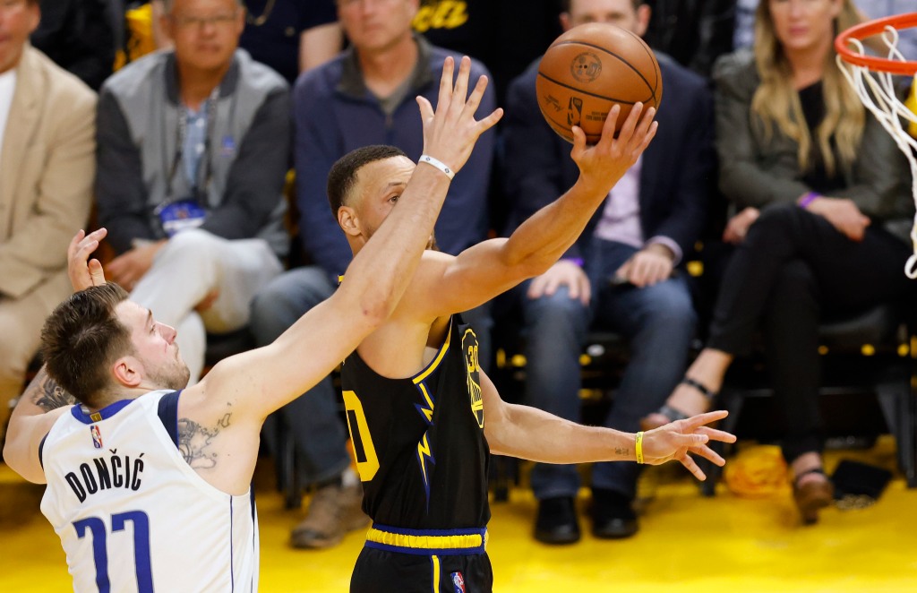 Stephen Curry blows past Luka Doncic for a layup during the Warriors' 112-87 Game 1 win over the Mavericks.