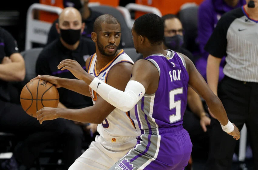 SACRAMENTO, CALIFORNIA - DECEMBER 27: Chris Paul #3 of the Phoenix Suns is guarded by De'Aaron Fox #5 of the Sacramento Kings at Golden 1 Center on December 27, 2020 in Sacramento, California. NOTE TO USER: User expressly acknowledges and agrees that, by downloading and or using this photograph, User is consenting to the terms and conditions of the Getty Images License Agreement. (Photo by Ezra Shaw/Getty Images)