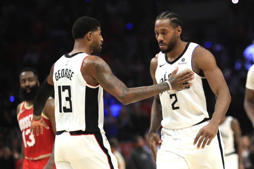 Kawhi Leonard #2 is congratulated by Paul George #13 of the Los Angeles Clippers during a game against the Houston Rockets