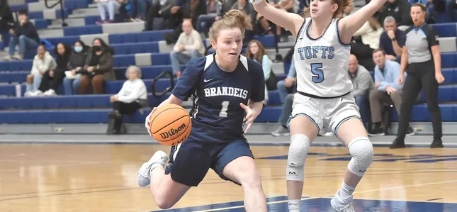 Lulu Ohm drives the lane with a Tufts defender off her left shoulder