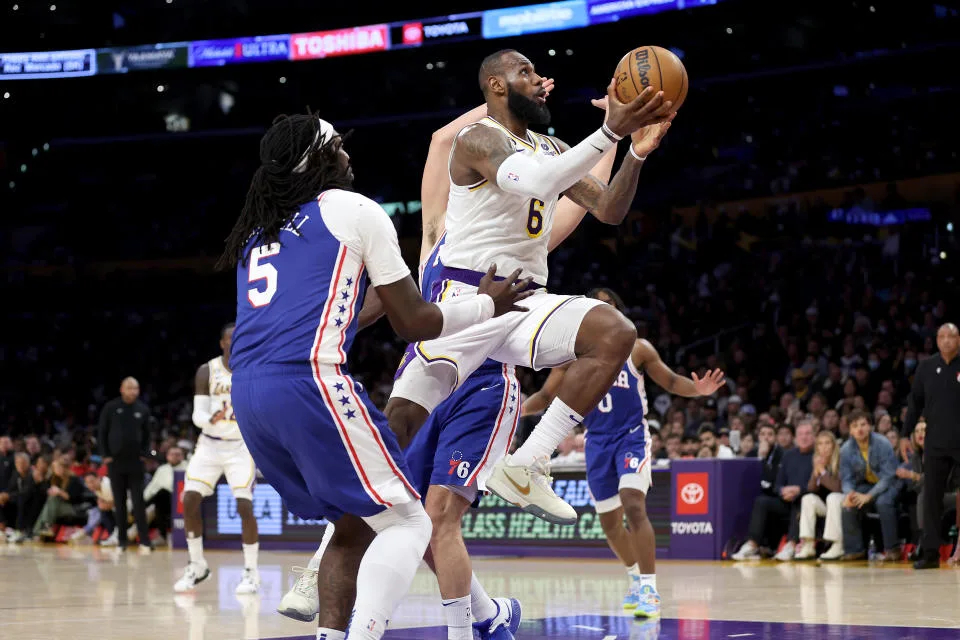 LOS ANGELES, CALIFORNIA - JANUARY 15:  LeBron James #6 of the Los Angeles Lakers dribbles to the basket past the defense of Montrezl Harrell #5 of the Philadelphia 76ers during the second half of a game at Crypto.com Arena on January 15, 2023 in Los Angeles, California.  NOTE TO USER: User expressly acknowledges and agrees that, by downloading and or using this photograph, User is consenting to the terms and conditions of the Getty Images License Agreement. (Photo by Sean M. Haffey/Getty Images)