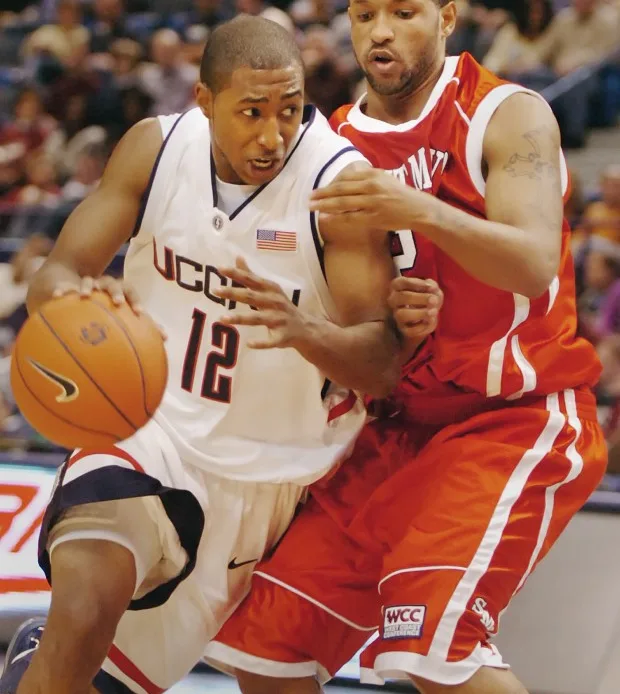 Connecticut's A.J. Price drives to the hoop against St. Mary's Tron Smith during the first half of their basketball game at the Hartford Civic Center in Hartford, Conn., on Sunday, Dec. 17, 2006. (AP Photo/Fred Beckham)