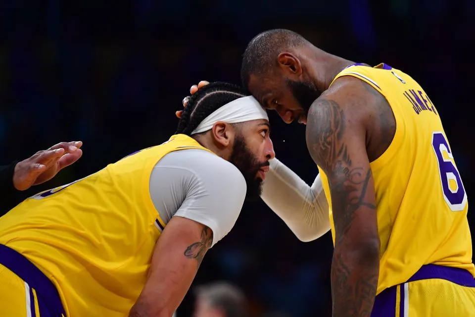 Los Angeles Lakers forward LeBron James speaks with forward Anthony Davis during a stoppage in play during the second half against the Minnesota Timberwolves.