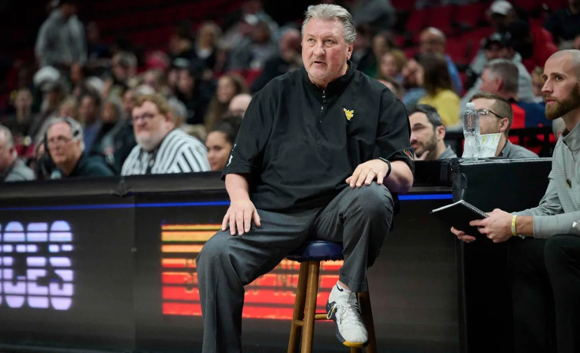 West Virginia suspends coach Bob Huggins, reduces salary $1 million for using homophobic slur on radio