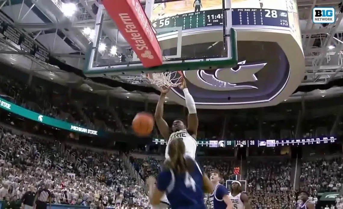 Michigan State's Mady Sissoko throws down a powerful two-handed dunk over a Georgia Southern defender