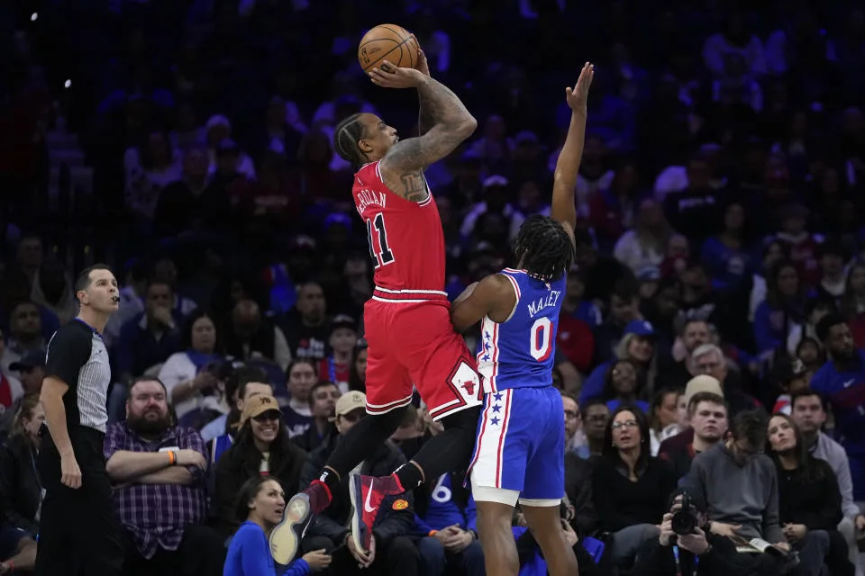 Chicago Bulls' DeMar DeRozan, left, goes up for a shot against Philadelphia 76ers' Tyrese Maxey during the first half of an NBA basketball game, Tuesday, Jan. 2, 2024, in Philadelphia. (AP Photo/Matt Slocum)