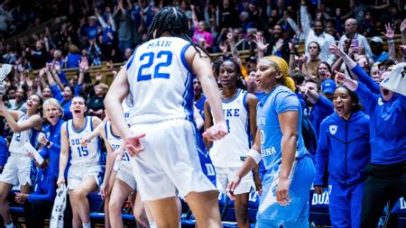 Taina Mair and the Duke bench celebrate following Mair's dagger three