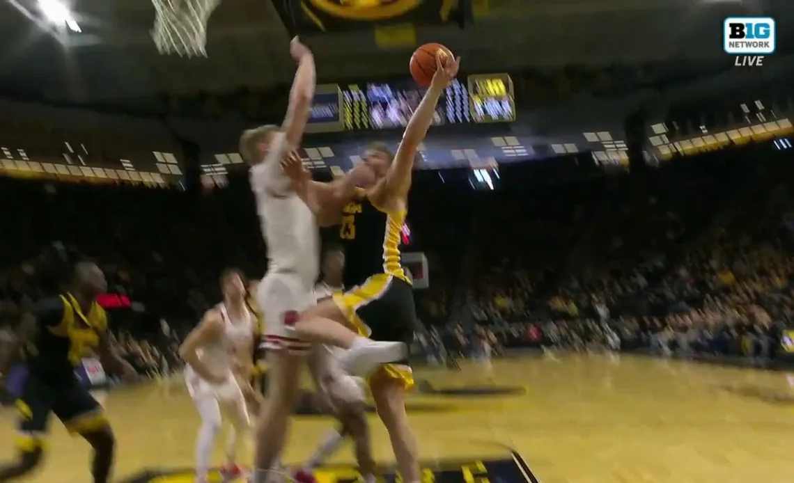 Wisconsin's Steven Crowl stuffs Iowa's Ben Krikke with an emphatic block