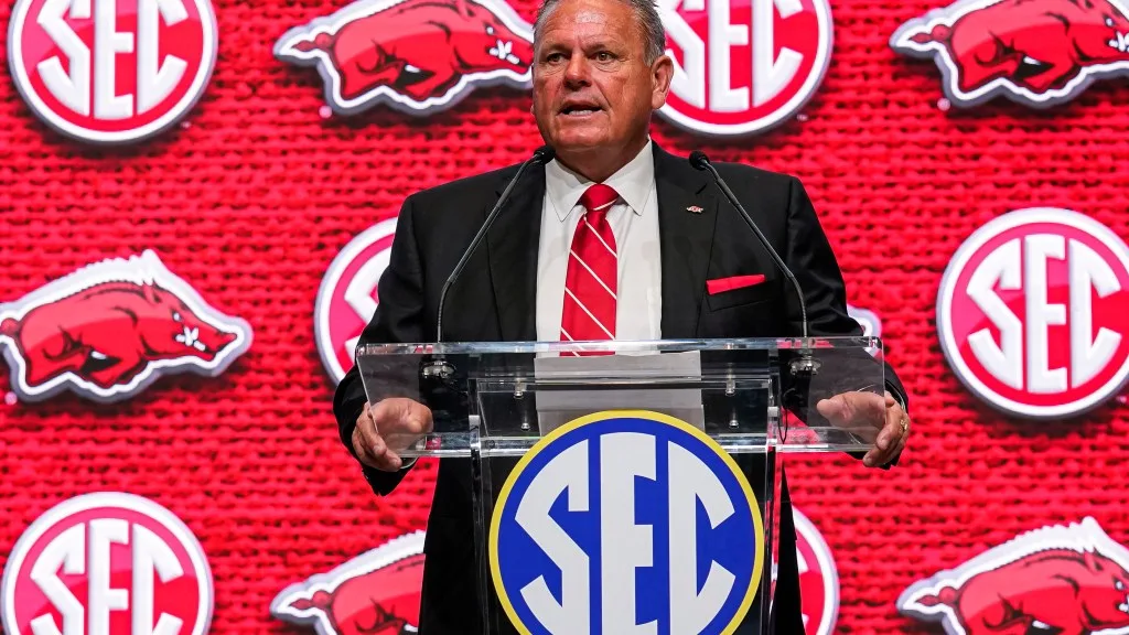 Arkansas football coach Sam Pittman gives advice to new Hogs basketball coach